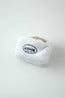 Close-up of the Afternoon Tea white plush pouch with a hidden toy