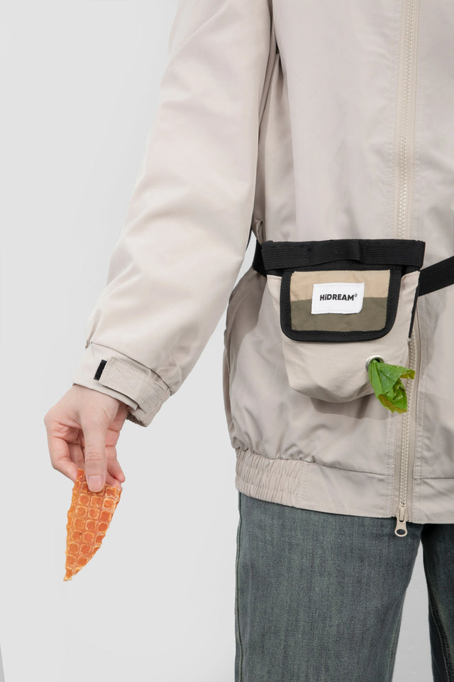 HiDREAM TreatTrail dog training pouch worn at the waist with treats