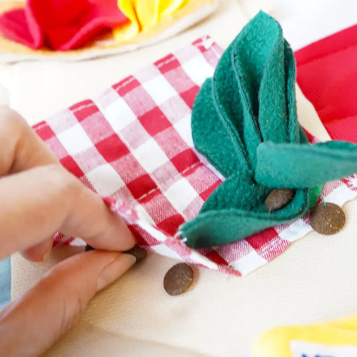 Close-up of fabric treat pockets and leafy knot on the Picnic Paws snuffle mat