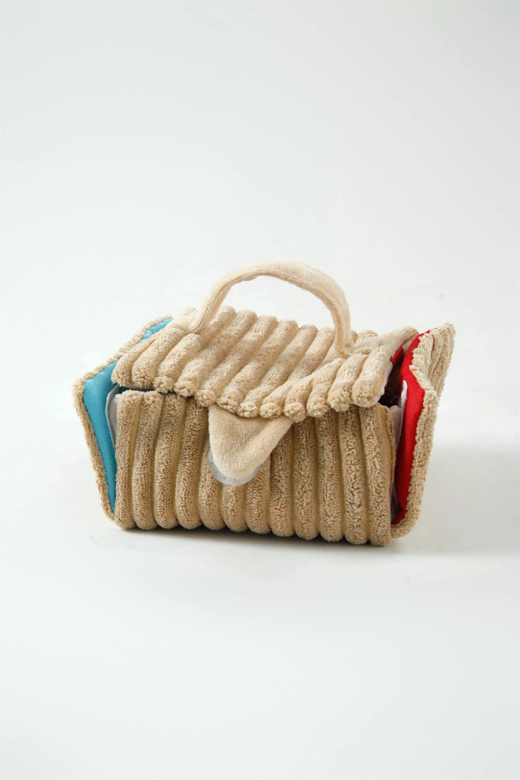 Close-up of the folded Picnic Paws snuffle mat and plush trim
